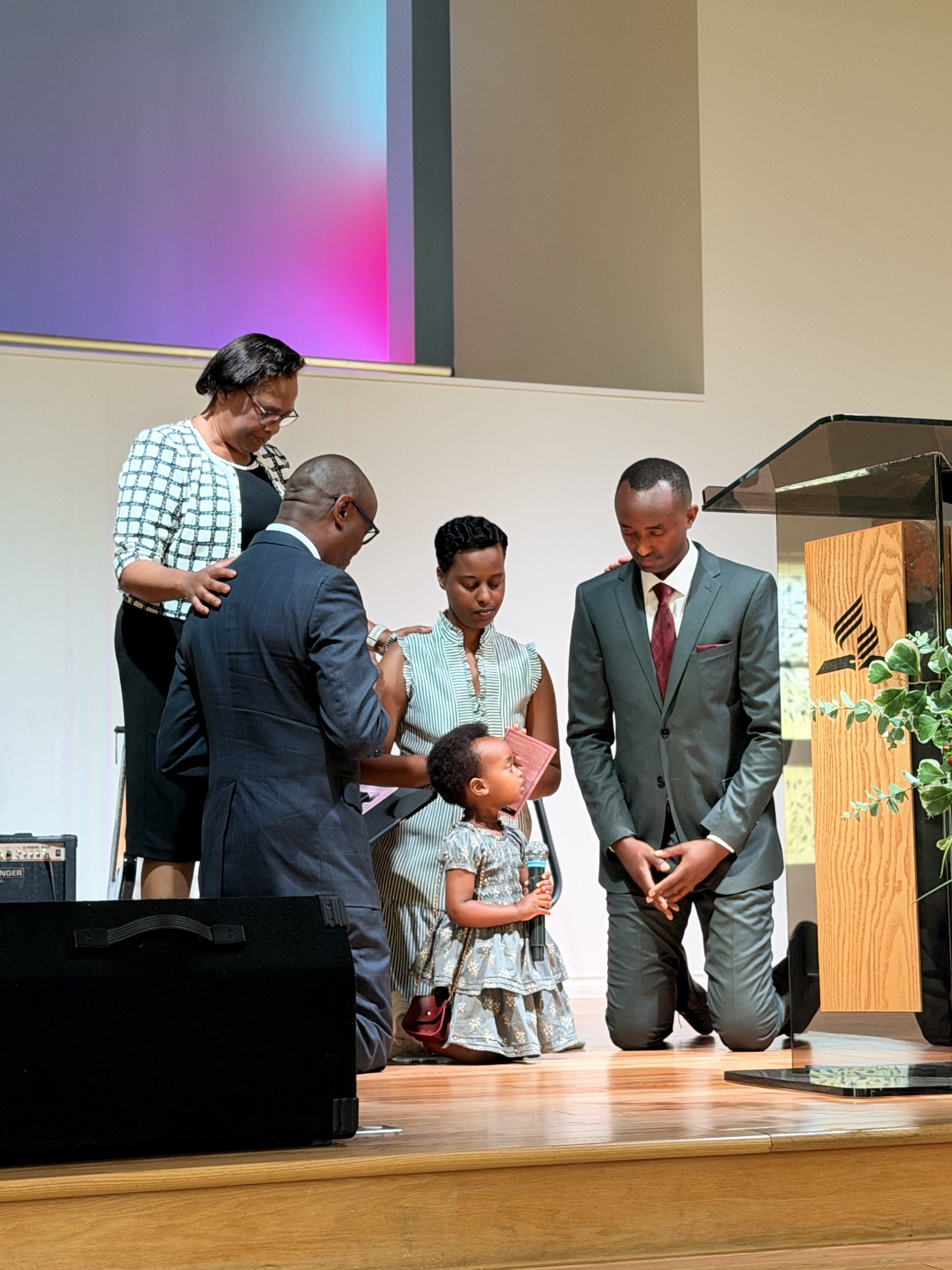 Pastor Maxi prays over Pastor Sano and family
